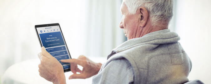 old man using the tablet